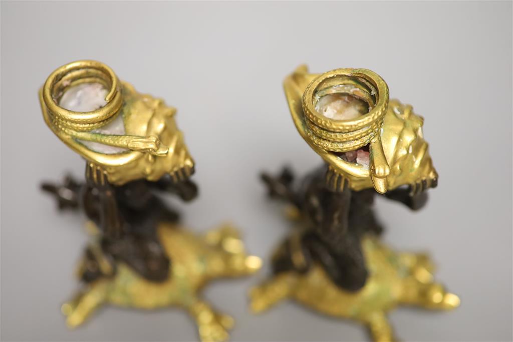 Two bronze and gilt metal candlesticks, modelled as Triton riding a tortoise, height 16.5cm